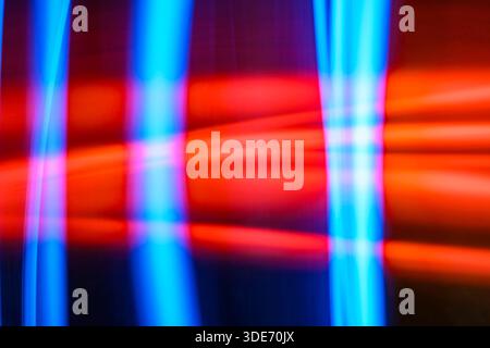 Abstract image features a blurred light painting technique, showcasing vibrant hues of red and blue in geometric shapes. The dynamic composition creat Stock Photo