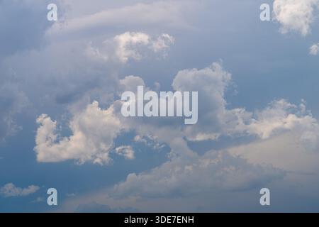 A breathtaking and stunning view showcasing fluffy clouds beautifully scattered across a serene blue sky overhead Stock Photo