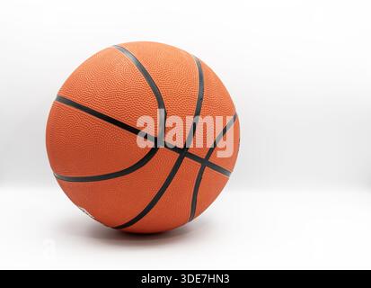 Orange basketball ball with textured rubber surface isolated on white background Stock Photo