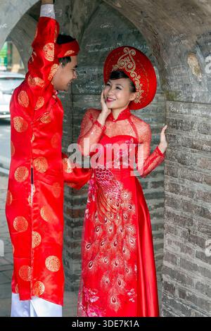 Vietnamese couple posing for wedding photos in formal traditional clothes, Hanoi, Vietnam Stock Photo