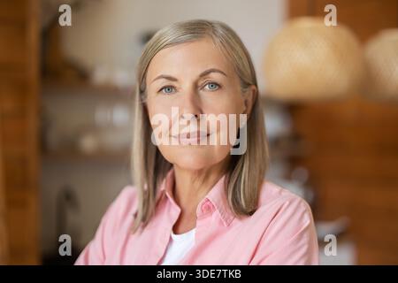Elderly lady posing casually indoors with relaxed expression Stock Photo