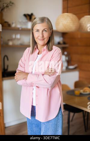 Elderly lady posing casually indoors with relaxed expression Stock Photo