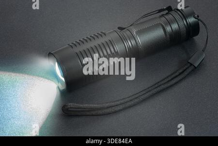 hand flashlight close-up, on a black background Stock Photo