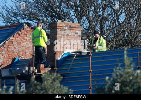 Builders working on a chimney in Baltimore, West Cork, Ireland. Stock Photo