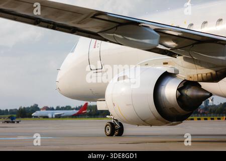 Traffic at airport on sunny day. Close-up view taxiing passenger airplane to runway for take off. Stock Photo