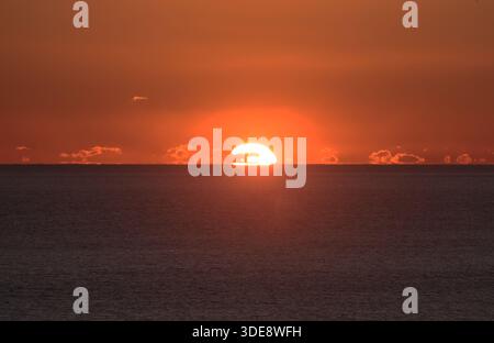 Sunset over the sea taken from the beach at Shoreham by Sea West Sussex Stock Photo