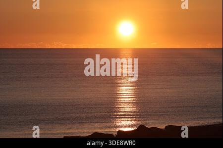 Sunset over the sea taken from the beach at Shoreham by Sea West Sussex Stock Photo