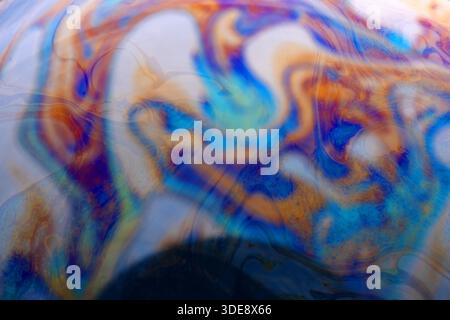 Vibrant abstract pattern with swirling blue, orange, and purple tones. Ideal for backgrounds, artistic designs, and creative projects. Stock Photo