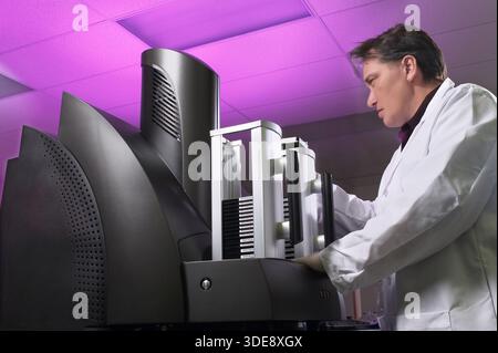 Man using electrochemiluminescence technology equipment in healthcare scientific laboratory, New Jersey, USA Stock Photo