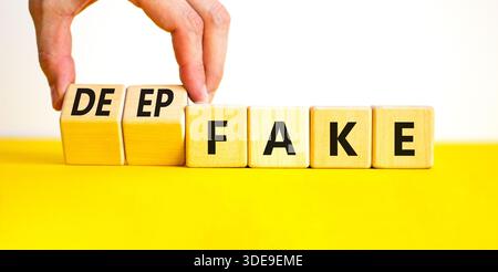 Deepfake or fake symbol. Concept words Fake Deepfake on wooden cubes. Beautiful yellow table white background. Businessman hand. Business and deepfake Stock Photo