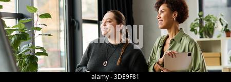 Dynamic scene in a modern office where two female managers collaborate and share ideas, banner Stock Photo