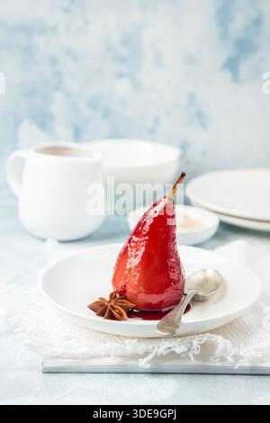 poached pears in spicy red wine syrup, selective focus Stock Photo