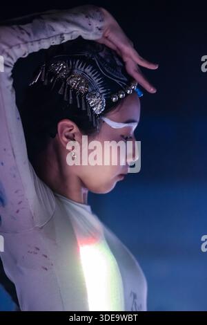 Fine art portrait of a contemporary Asian female dancer at a stage performance. A poetic fusion of Chinese dance and cultural symbolism with elegance. Stock Photo