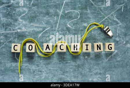 business coaching concept,qualification, further education concept,teambuilding with whistle of a soccer referee on black board Stock Photo