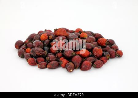 Pile of dried rose hips (disambiguation) on a white background. Natural healthy product for making tea. Studio shot. Stock Photo