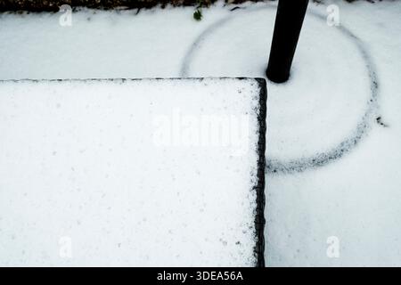 Abstract patterns in the snow on garden furniture Stock Photo