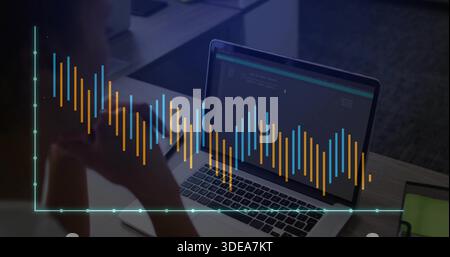 Reviewing code woman wearing dark top viewing laptop in office, data overlay notebook, copy space Stock Photo