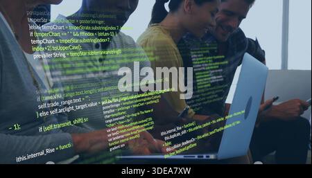 Coding dev team leaning toward laptops at bench by window, yellow top, Apple logo, code overlay Stock Photo