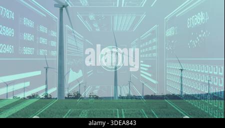 Displaying central turbine rotating over grassy field near distant tree line with data HUDs Stock Photo