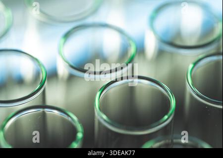 Female chemistry scientist doing experiments in lab. Pipette adding colorful solution in tubes, medical abstract background. Stock Photo