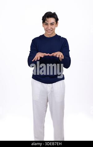 Young man in casual clothes posing with hands down. Stock Photo