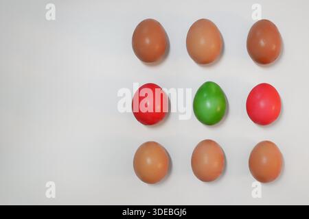 Minimal flat lay of colorful Easter eggs arranged in a grid on white background. Spring holiday concept for Easter celebration, decoration, greeting c Stock Photo