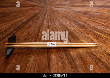 Tobi Masa, a high-end Japanese restaurant in London, featuring chopsticks (hashi) resting on a ceramic hashioki chopstick rest. Stock Photo