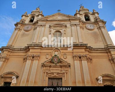 Entrance facade of St. Paul's Cathedral in the ancient fortified city of Mdina, Malta. The image highlights the detailed baroque limestone architectur Stock Photo