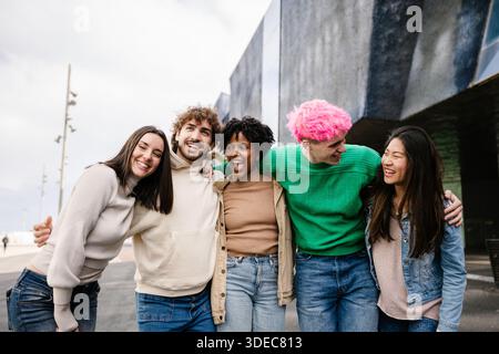 Young diverse group of friends walking together outdoors Stock Photo