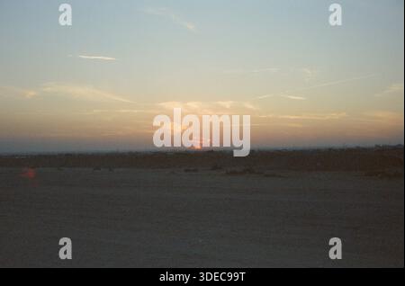 Sun Setting over desert in Saudi Arabia Stock Photo