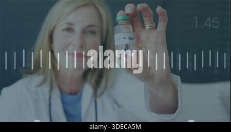 Holding COVID-19 vial, female doctor offering it in clinic with white coat, stethoscope overlay Stock Photo