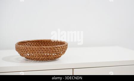 Empty rattan wicker basket on wooden cabinet Stock Photo