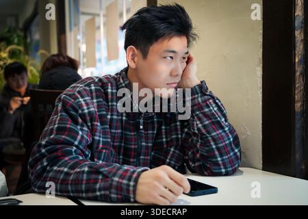 Young asian man having stressful time Stock Photo