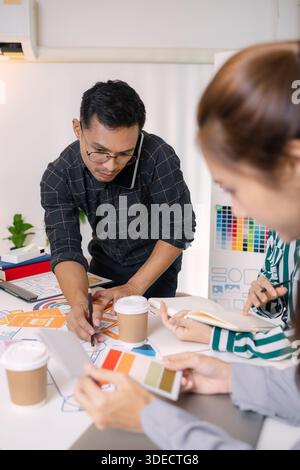 UX/UI designers presenting their final design project to the team, showcasing app interface screens and explaining user experience strategies in a pro Stock Photo