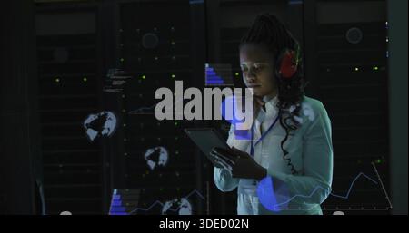 Checking LEDs, tech holding tablet, checking HUD in datacenter, white shirt, red headset lanyard Stock Photo