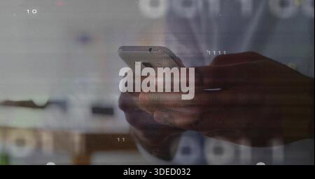 Holding dark-skinned male hands typing on smartphone at workspace, with digital overlays visible Stock Photo