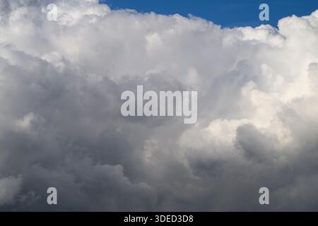 An incredibly impressive and captivating view of thick clouds layered beautifully against the vibrant blue sky Stock Photo
