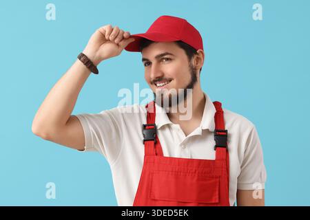 Portrait of male worker on blue background Stock Photo