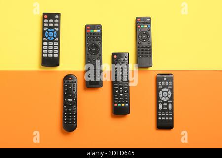 Different modern TV remote controls on color background Stock Photo