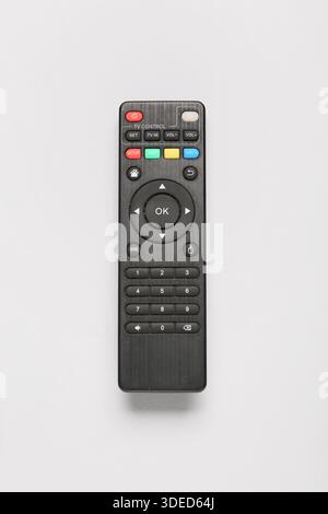 Modern TV remote controls on grey background Stock Photo