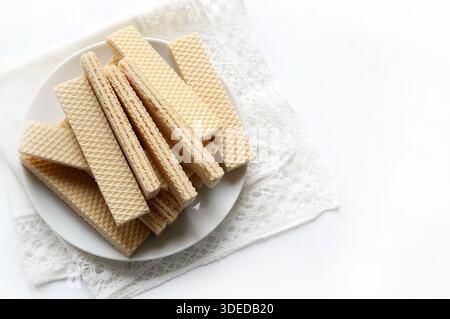 Wafer plate on a white background. They are biscuits made up of layers of thin, crunchy wafer with a cream filling. Stock Photo
