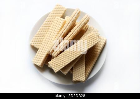 Wafer plate on a white background. They are biscuits made up of layers of thin, crunchy wafer with a cream filling. Stock Photo