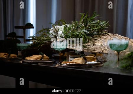 Mystical forest theme of decorating a festive table for catering. Heavy smoke coming from a glass on a set table Stock Photo