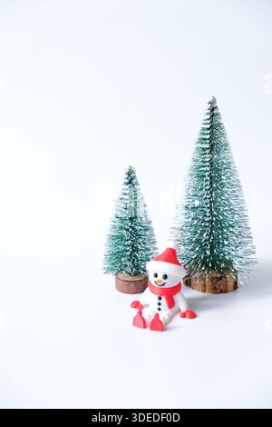 Decorative mini christmas tree with snowman isolated on white background Stock Photo