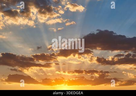 Dramatic colorful sunset with cloudy sky. Beautiful twilight. Golden hour Stock Photo
