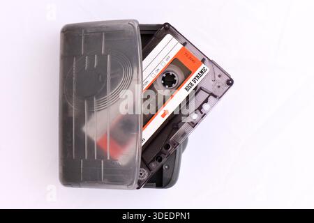 Vintage portable cassette player with Santa 46 High Dynamic audio tape being inserted. Retro 1980s analog music technology on a white background. Stock Photo