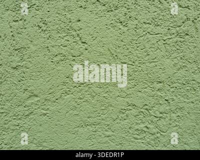Wall with coarse, rough scraped plaster in light green. Copyspace Stock Photo