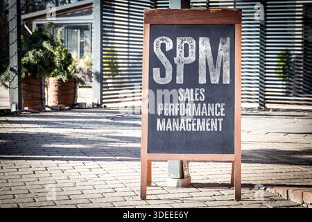 SPM Sales Performance Management Concept Shown On Outdoor Chalkboard Sign In Sunlit Urban Environment Stock Photo