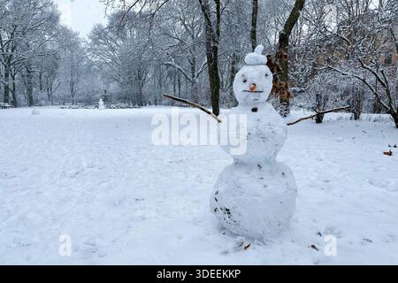 Classic Snowman in Berlin Kreuzberg on a snowy winter day at Grimmstrasse park.  Stock Photo
