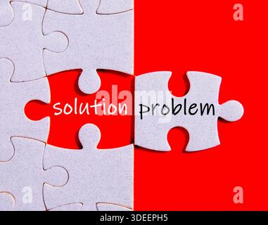 Jigsaw puzzle showing a white piece with word problem and missing piece revealing solution Stock Photo